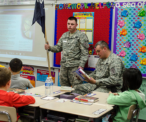 Soldiers read books to students at Bergman Elementary