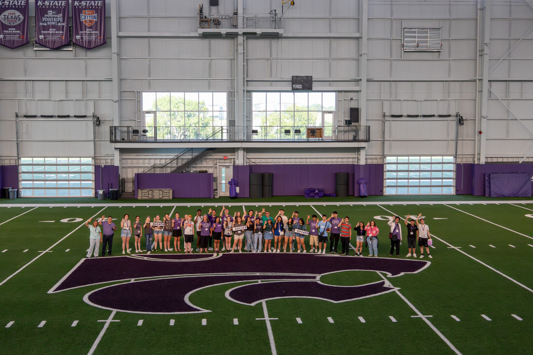 students with in football training facility 