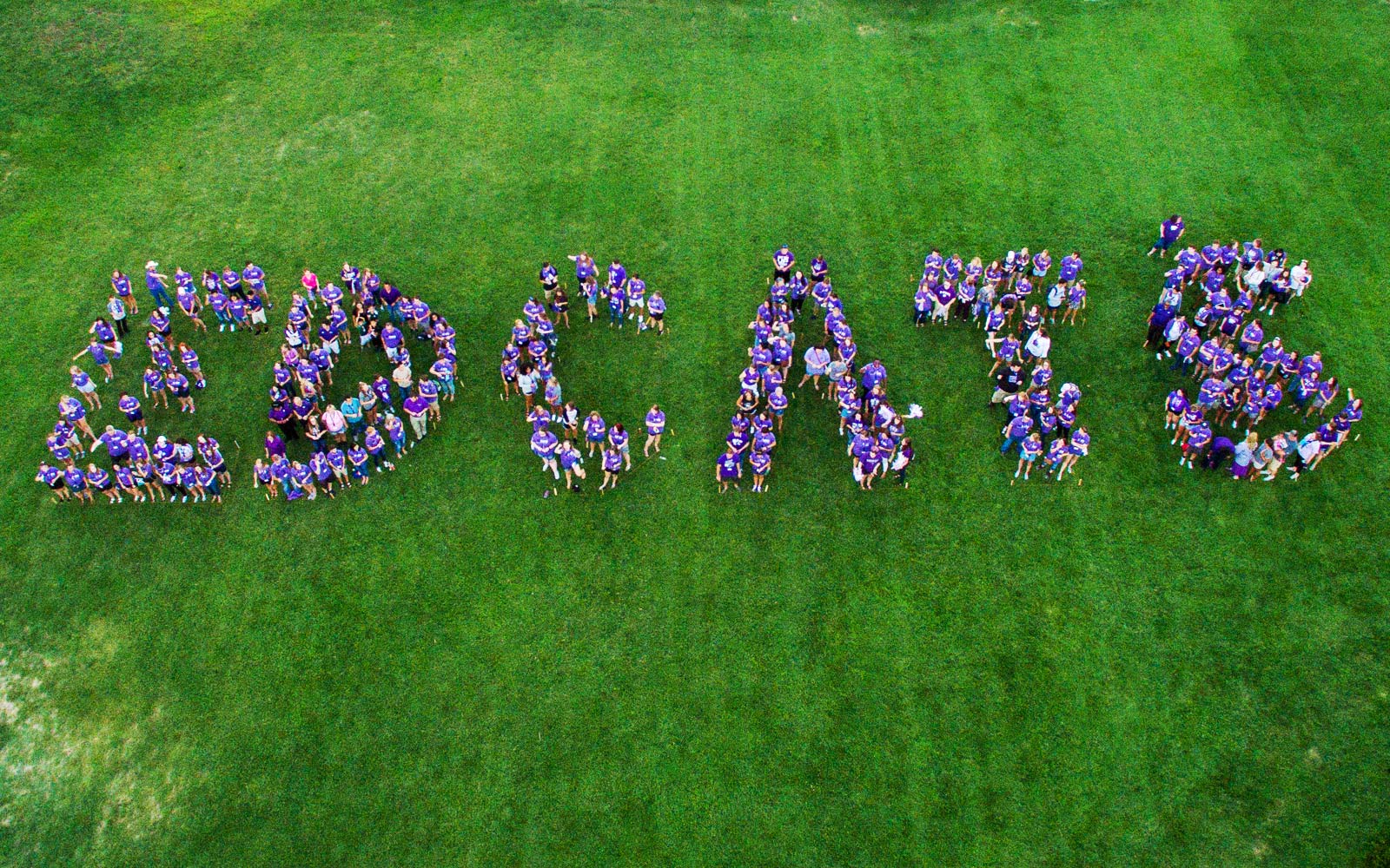drone photo from above Anderson lawn with students spelling out the word EDCATS